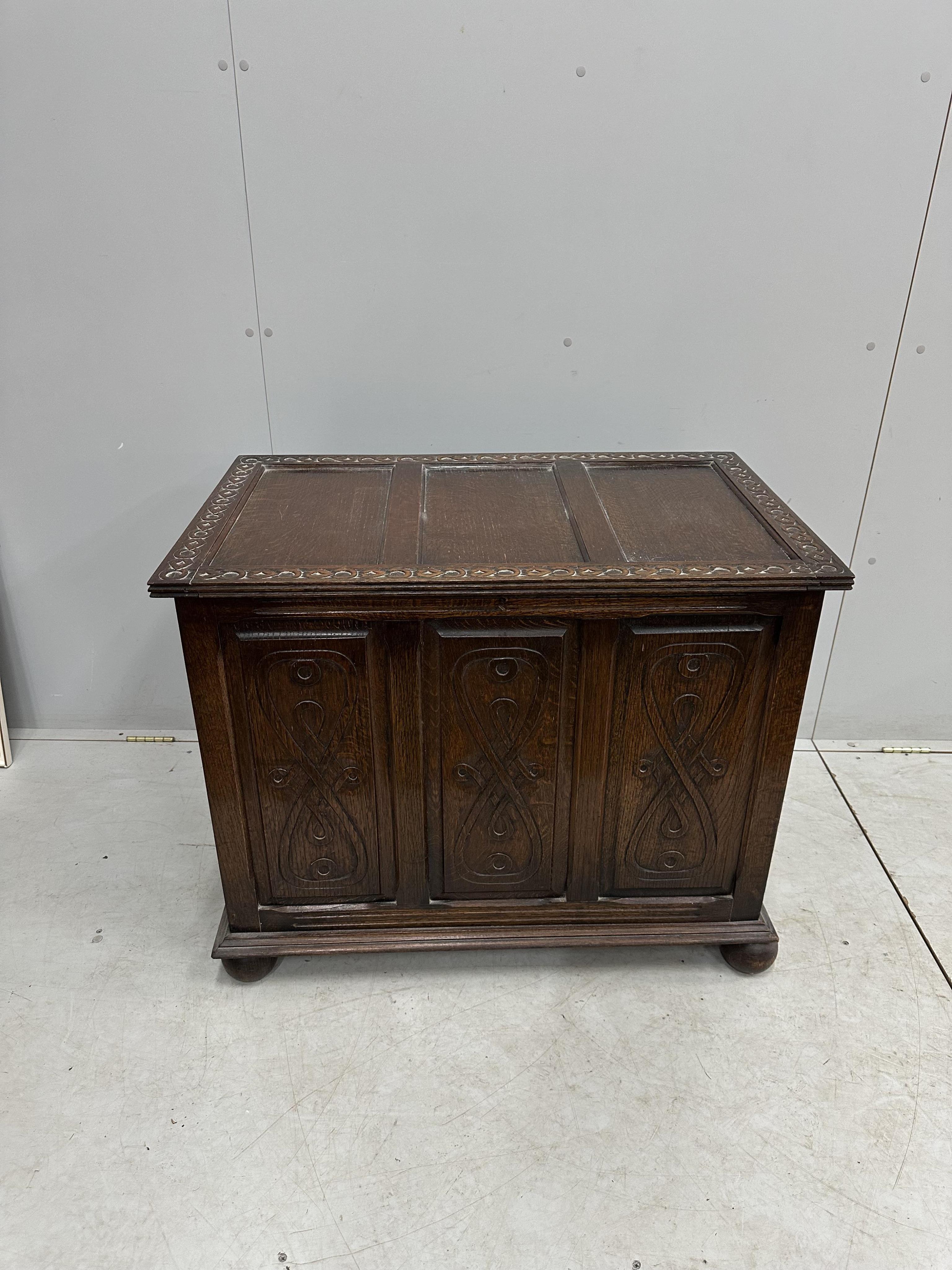 A 1930's carved oak coffer, width 91cm, height 73cm. Condition - good